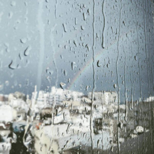 raining and rainbow outside a window